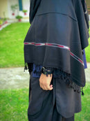 Our Pashmina black wool shawl is luxuriously crafted with a harmonious blend of fine wool and silk poly blend. It's lightweight and provides superior insulation so you'll always remain cozy without the worry of added bulk. Thi s timeless piece is idea.